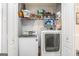 Functional laundry room with washer, dryer, and storage shelves at 149 Crown Oaks Dr, Stockbridge, GA 30281