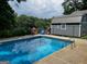 In-ground pool with ladder and fence with chairs and storage shed at 149 Crown Oaks Dr, Stockbridge, GA 30281