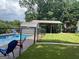 In-ground pool area with storage shed, carport, and mature trees at 149 Crown Oaks Dr, Stockbridge, GA 30281