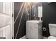 Stylish powder room features gray walls, decorative mirror, modern vanity and crystal hardware at 2780 Lakeview Walk, Decatur, GA 30035