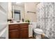 Bright bathroom with wooden cabinets, a toilet, and shower with a decorative curtain at 2780 Lakeview Walk, Decatur, GA 30035
