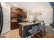 Open-concept kitchen features granite counters, stainless steel appliances, tile floors, and bar stool seating at 2780 Lakeview Walk, Decatur, GA 30035