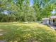 Lush, expansive backyard with mature trees and a comfortable bench perfect for relaxation at 30 Court, Ellenwood, GA 30294