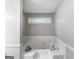 Soaking tub with tile surround and window in this cozy bathroom at 30 Court, Ellenwood, GA 30294