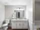 Bright bathroom with decorative mirror, granite vanity, white cabinets, and toilet at 30 Court, Ellenwood, GA 30294