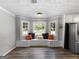 Cozy breakfast nook features custom bench seating, soft lighting and a view of the backyard at 30 Court, Ellenwood, GA 30294