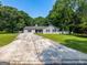 Ranch style home with mature trees, a long driveway and covered parking at 30 Court, Ellenwood, GA 30294