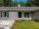 Inviting home exterior features a black front door, symmetrical windows and dark shutters at 30 Court, Ellenwood, GA 30294