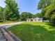 Charming home with a manicured lawn, mature trees, and a long driveway at 30 Court, Ellenwood, GA 30294