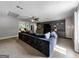 Large living room features custom shelving, neutral walls and plush carpeting for a comfortable and inviting space at 30 Court, Ellenwood, GA 30294