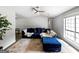Bright living room with a ceiling fan, hardwood floors, and a comfortable couch at 30 Court, Ellenwood, GA 30294