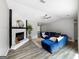 Cozy living room features a painted fireplace, ceiling fan, and hardwood floors at 30 Court, Ellenwood, GA 30294