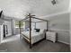 This main bedroom features a stylish canopy bed, soft gray walls and neutral carpet at 30 Court, Ellenwood, GA 30294