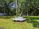 Relaxing tree bench nestled in the shade in the expansive backyard with lush green grass at 30 Court, Ellenwood, GA 30294