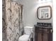 Classic bathroom featuring a dark wood vanity, black countertop, and patterned shower curtain at 420 Heritage Park Nw Trce # 22, Kennesaw, GA 30144