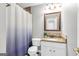 Well-lit bathroom with a granite vanity, white cabinets, and a shower with a patterned curtain at 420 Heritage Park Nw Trce # 22, Kennesaw, GA 30144