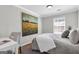 Comfortable bedroom with an oversized painting, a bedside desk, a window with blinds, and carpet at 420 Heritage Park Nw Trce # 22, Kennesaw, GA 30144