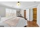 Bright bedroom with a large window, closet access, and a decorative throw blanket, creating a comfortable space at 420 Heritage Park Nw Trce # 22, Kennesaw, GA 30144