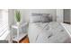 Bright bedroom with a decorative side table, window view, and plush bedding, making it an inviting space at 420 Heritage Park Nw Trce # 22, Kennesaw, GA 30144
