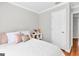 Cozy bedroom featuring plush bedding, side table with decor, and hardwood flooring at 420 Heritage Park Nw Trce # 22, Kennesaw, GA 30144
