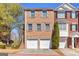 Charming two-story townhouse with red brick facade, grey shutters, and two-car garage at 420 Heritage Park Nw Trce # 22, Kennesaw, GA 30144