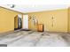 Spacious garage with yellow walls, concrete flooring, and an electric car charger at 420 Heritage Park Nw Trce # 22, Kennesaw, GA 30144