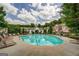 Community pool with lounge chairs and meticulously maintained grounds surrounded by mature trees at 420 Heritage Park Nw Trce # 22, Kennesaw, GA 30144