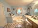 Bathroom featuring a jacuzzi tub with tile surround and separate vanity area at 7133 Babbling Brook Dr, Jonesboro, GA 30236
