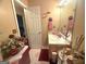 Bathroom featuring a single sink vanity, floral decor, and tile flooring at 7133 Babbling Brook Dr, Jonesboro, GA 30236