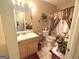 Bathroom featuring a single sink vanity, floral decor, and tile flooring at 7133 Babbling Brook Dr, Jonesboro, GA 30236