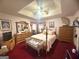 Spacious bedroom featuring a tray ceiling, comfortable seating, and natural light at 7133 Babbling Brook Dr, Jonesboro, GA 30236