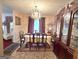 Formal dining room with a decorative chandelier, china cabinet and a table for six at 7133 Babbling Brook Dr, Jonesboro, GA 30236