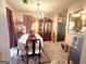 Elegant dining room featuring a chandelier, china cabinet, and seating for six at 7133 Babbling Brook Dr, Jonesboro, GA 30236