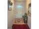 Inviting entryway with light wood floors, complemented by a decorative rug and a charming half-moon window at 7133 Babbling Brook Dr, Jonesboro, GA 30236