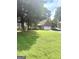 A quaint home with brick accents, surrounded by mature trees and lush green lawn, offering a serene setting at 7133 Babbling Brook Dr, Jonesboro, GA 30236