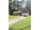 Charming single-story home with a brick facade, a well-maintained lawn, and an attached two-car garage at 7133 Babbling Brook Dr, Jonesboro, GA 30236