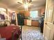 Eat-in kitchen features black appliances, wooden cabinetry, and tiled flooring at 7133 Babbling Brook Dr, Jonesboro, GA 30236