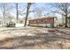 A long, brick home with a walkout basement sits in a leaf strewn backyard at 2522 Frost Sw Dr, Marietta, GA 30008