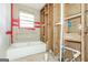 Bathroom featuring new plumbing and wall framing, a bright window, and a new tub ready for design and construction at 2522 Frost Sw Dr, Marietta, GA 30008