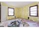 Bedroom under renovation, featuring two windows, abundant light, and great potential for updates at 2522 Frost Sw Dr, Marietta, GA 30008