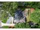 Aerial view of home with mature trees, large driveway, patio cover and well-maintained roof at 2676 Cottonwood Dr, Marietta, GA 30066