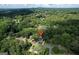 An aerial view of a house in a lush, green neighborhood with dense tree cover at 2676 Cottonwood Dr, Marietta, GA 30066