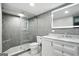 Modern bathroom featuring gray tile walls, glass shower with pebble floor and white vanity with marble countertop at 2676 Cottonwood Dr, Marietta, GA 30066