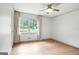 Comfortable bedroom with hardwood floors, ceiling fan, and a window view of the outdoors at 2676 Cottonwood Dr, Marietta, GA 30066