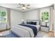 Bright bedroom featuring a ceiling fan, a bed, and two windows with curtains at 2676 Cottonwood Dr, Marietta, GA 30066