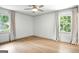 Bright bedroom featuring hardwood floors, large windows with curtains and a ceiling fan at 2676 Cottonwood Dr, Marietta, GA 30066