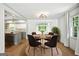Open-concept dining area featuring modern light fixtures, hardwood floors, and views to the kitchen at 2676 Cottonwood Dr, Marietta, GA 30066