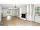 Bright living room featuring hardwood floors, a fireplace with built-in shelving, and ample natural light at 2676 Cottonwood Dr, Marietta, GA 30066