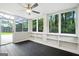 Bright sunroom with ceiling fan, black tile flooring and large windows offering views of the surrounding landscape at 2676 Cottonwood Dr, Marietta, GA 30066