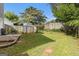 Backyard featuring a storage shed, a wood fence, and green grass at 4706 Cedar Park Trl, Stone Mountain, GA 30083
